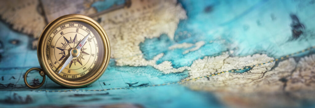Magnetic old compass on world map.Travel, geography, navigation, tourism and exploration concept background