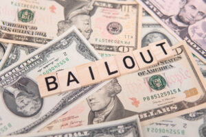 bailout inscription next to american dollars. Saving failing banks